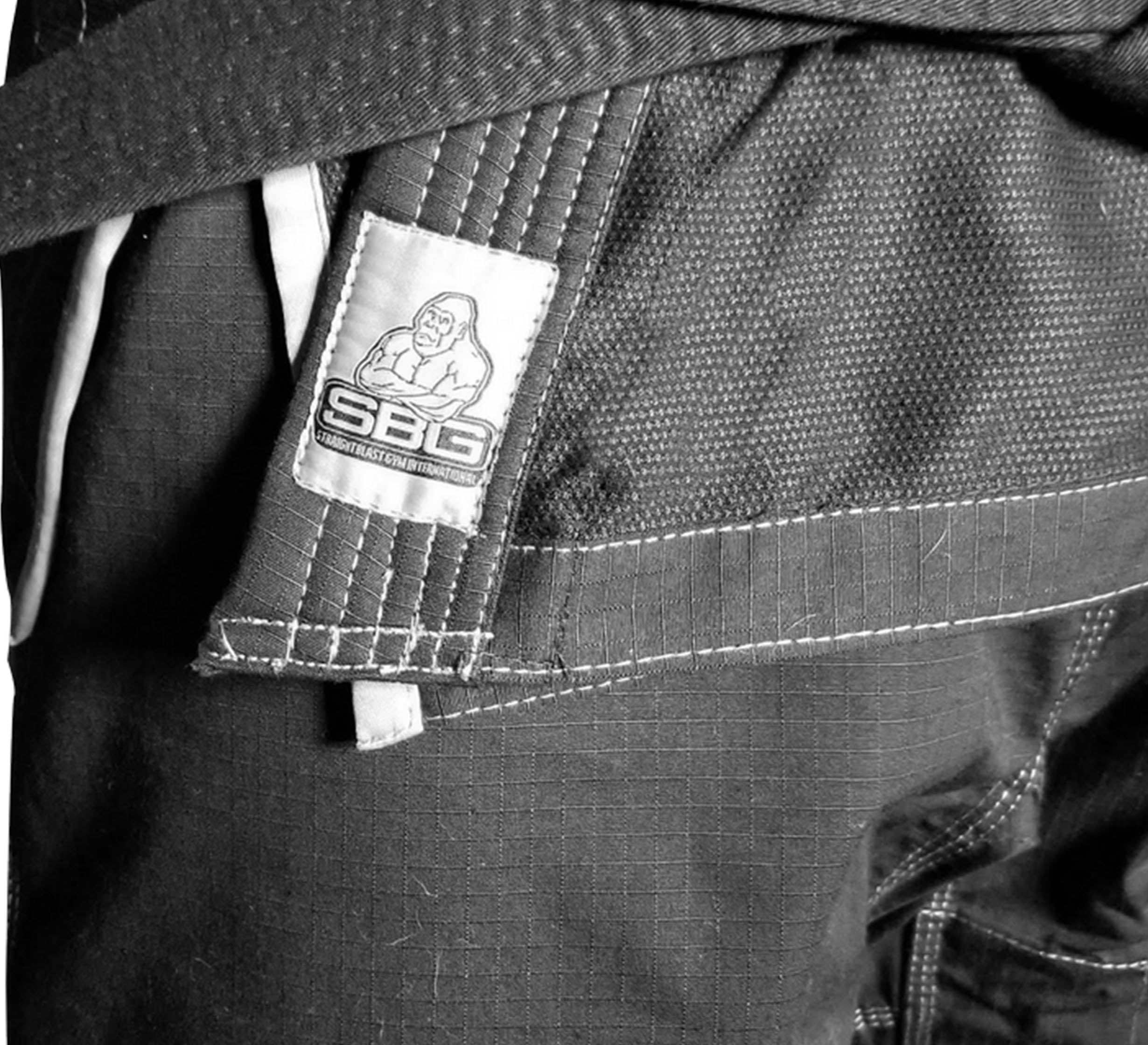 Close-up of SBG Super Lite Kids Gi pants featuring a patch with a gorilla illustration and SBG text in black and white.