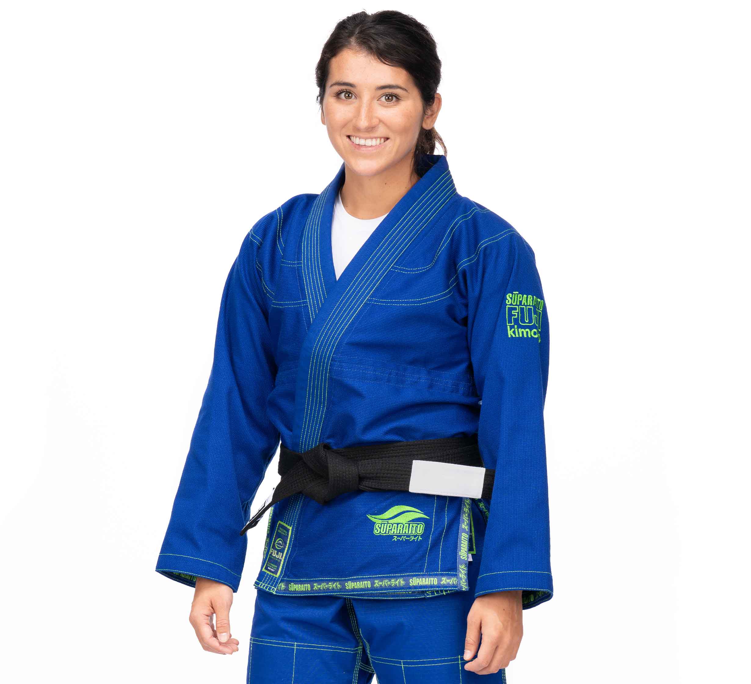 A woman wearing the Suparaito BJJ Gi (Unisex Size) in blue with a black belt smiles against a plain white background.