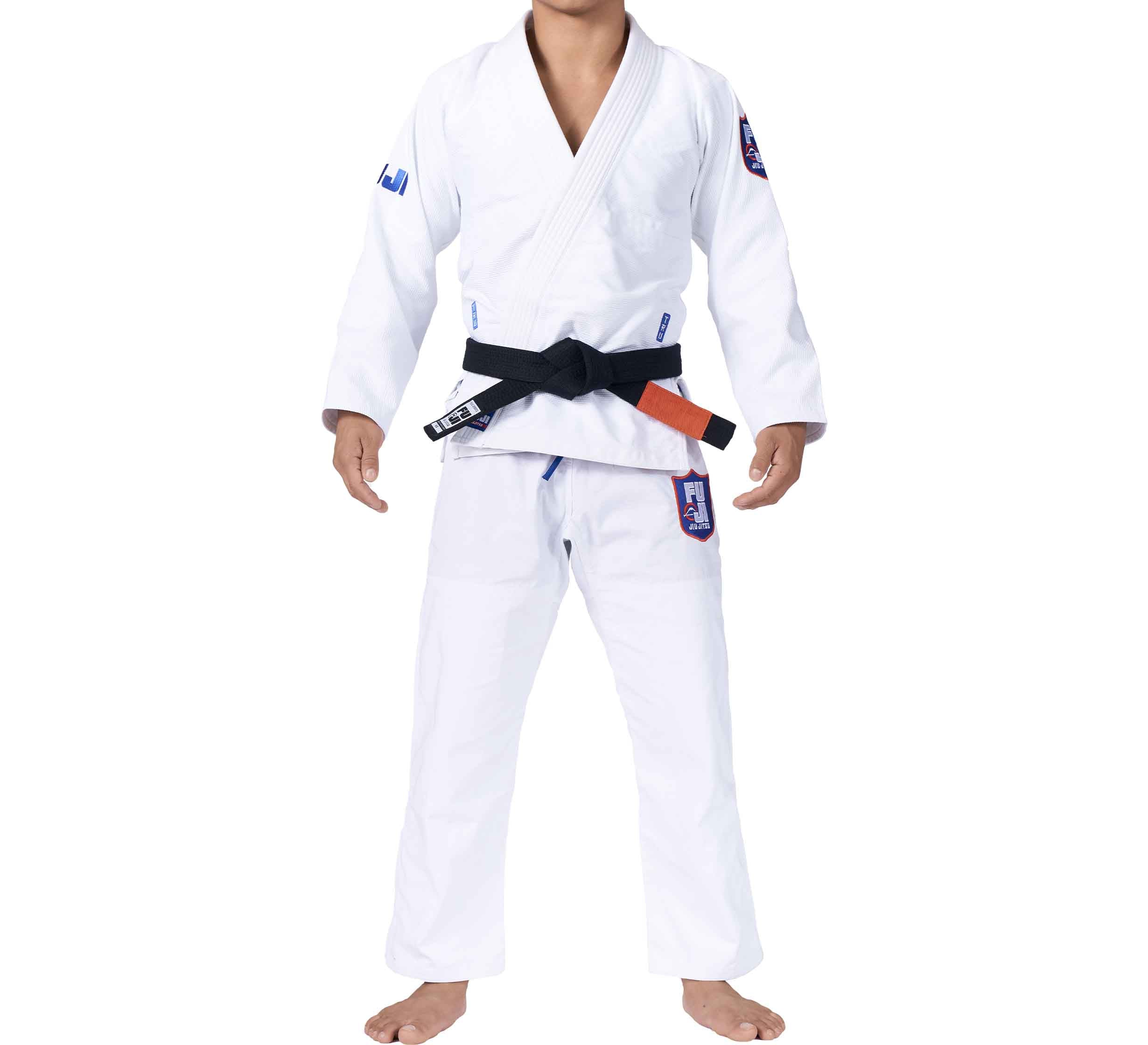 A person wears the TRU Fit BJJ Gi Bundle (2 Items)—a white gi with blue and red patches on sleeves and pants, plus a black belt—standing barefoot against a plain background.