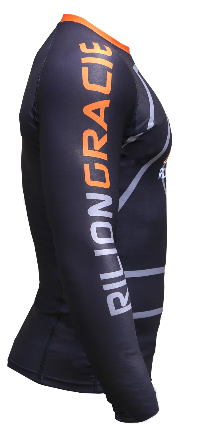 The Rilion Gracie Long Sleeve Kids Rashguard is a black athletic top featuring "RILLION GRACIE" in bold orange and white letters along the right arm and shoulder.