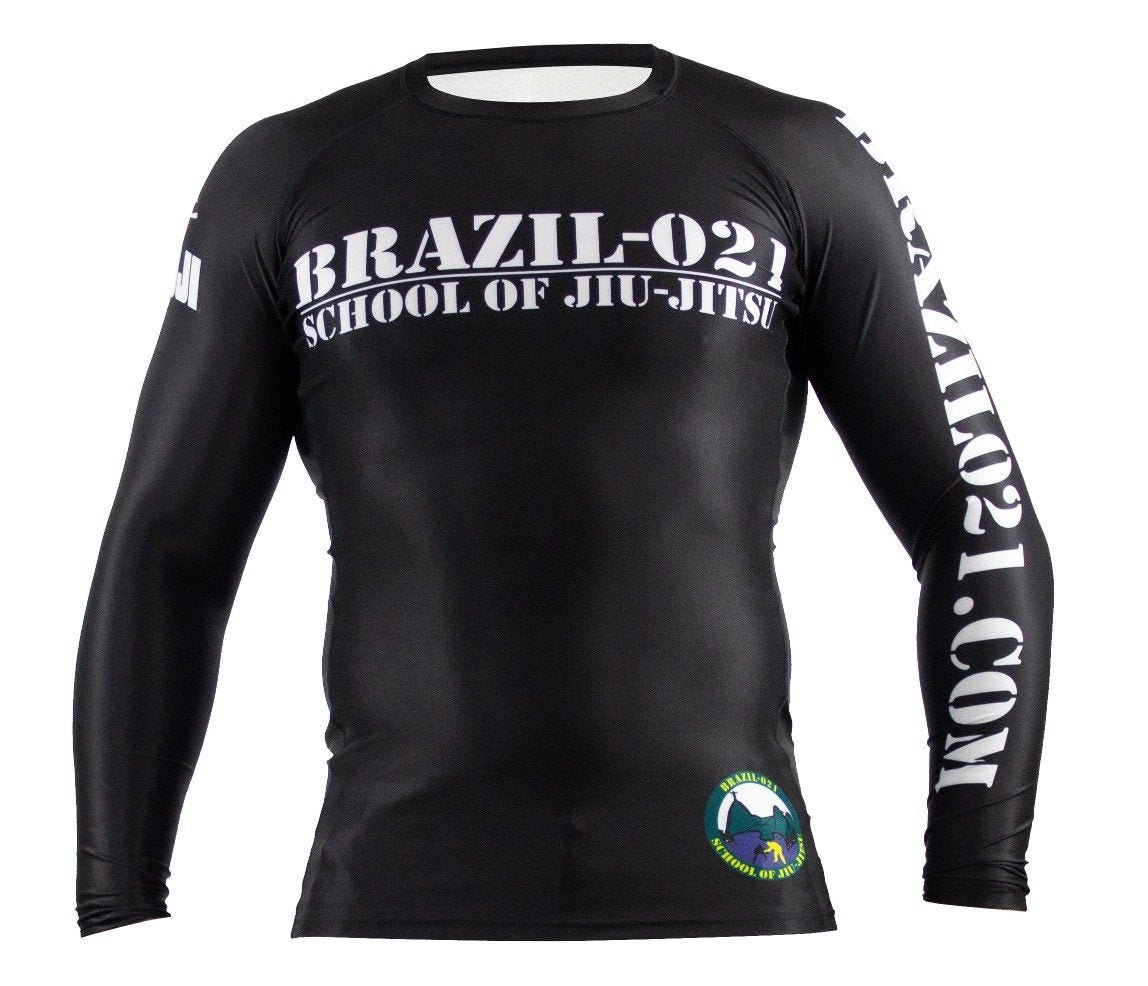 The BRAZIL 021 Ranked Rashguard is a black long-sleeve rash guard with "BRAZIL-021 SCHOOL OF JIU-JITSU" on the chest, "BRAZIL021.COM" on the right sleeve, and a green-and-blue circular patch by the left hip.