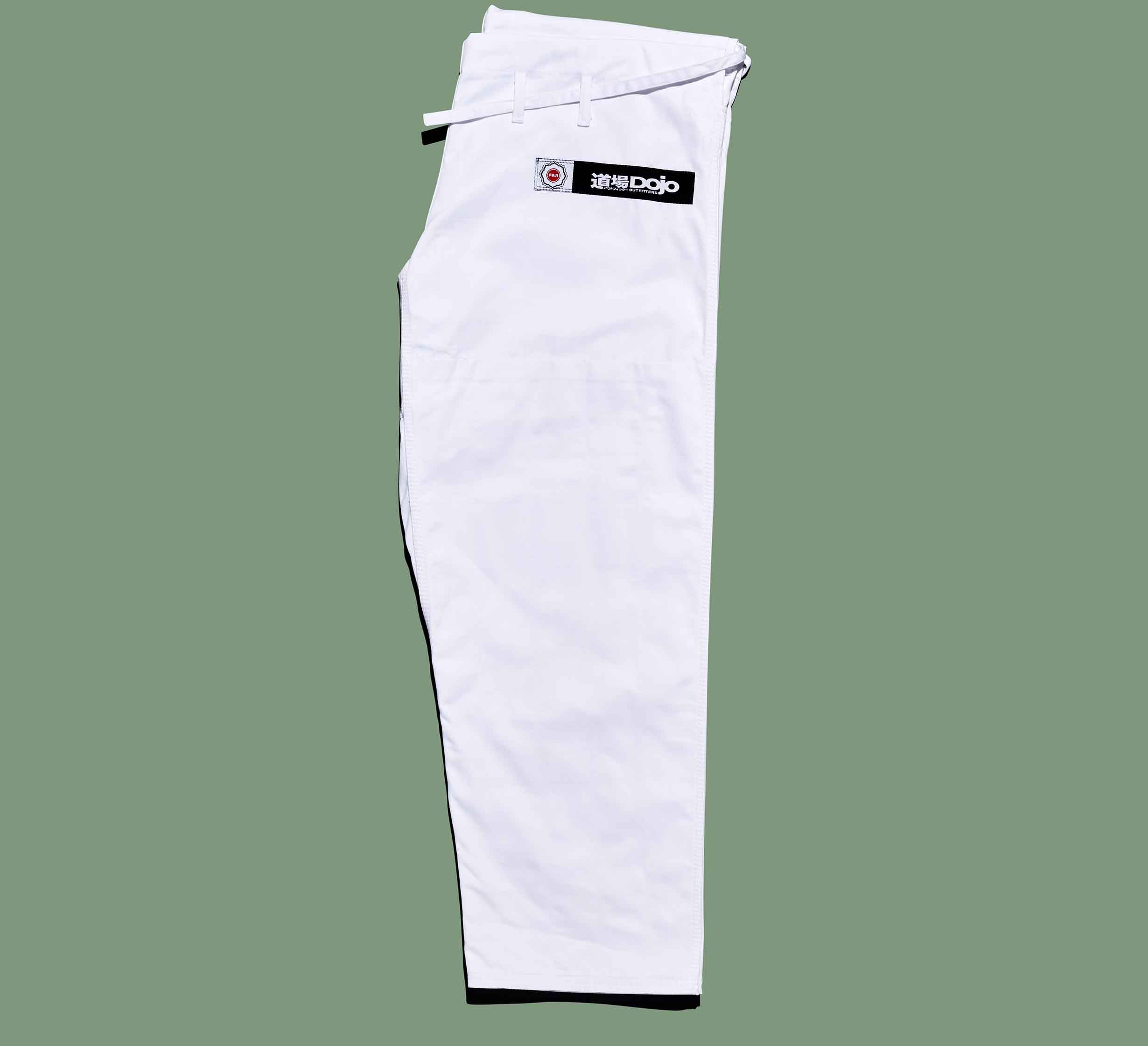 The Dojo Outfitters x FUJI Judo Gi features white martial arts pants with a belt and a black DOJO patch with Japanese characters, shown on a flat green background.