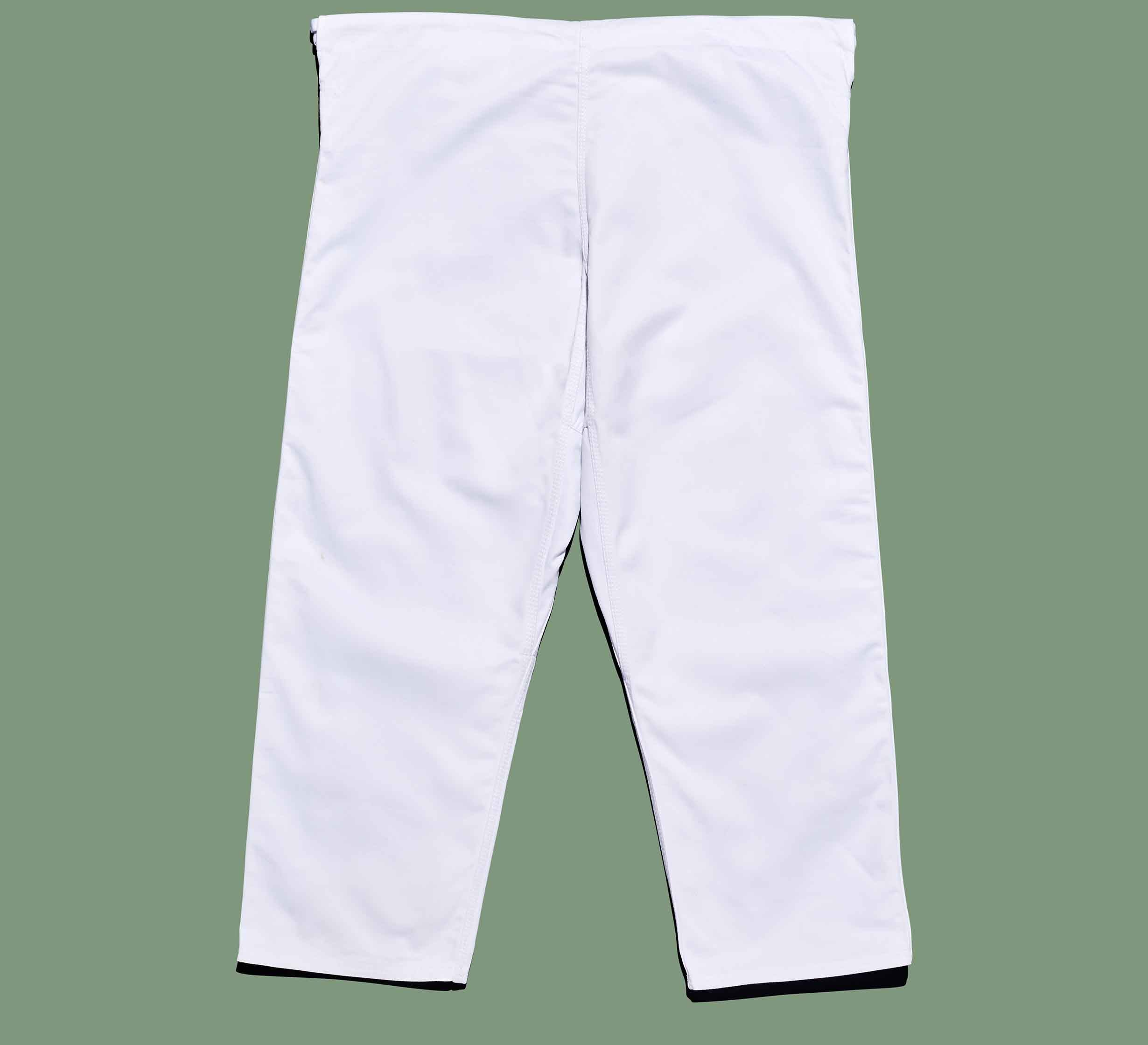 The Dojo Outfitters x FUJI Judo Gi pants are laid flat on a solid green background, with the legs slightly apart and the waistband positioned at the top.