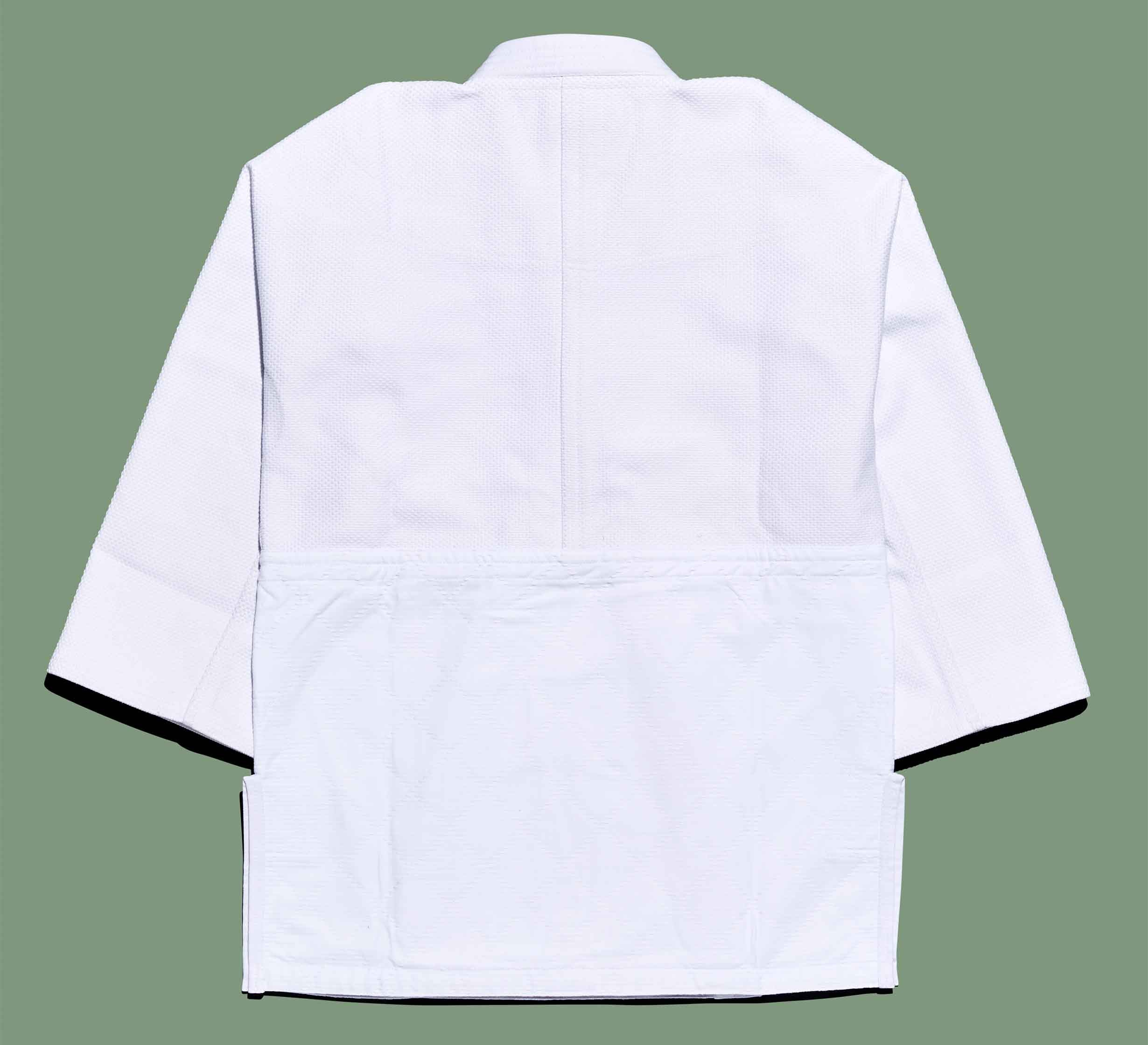 The Dojo Outfitters x FUJI Judo Gi jacket is displayed flat on a green background, showing the back view with visible sleeves and collar.