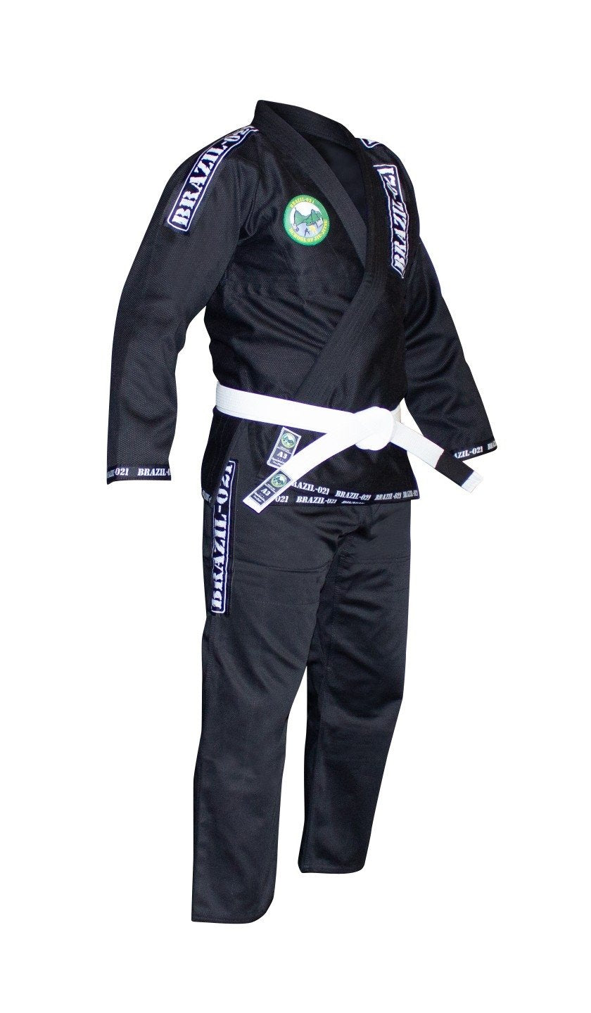 The BRAZIL 021 Adult BJJ Gi, in black with shoulder and pant patches, is displayed on a headless mannequin with a white belt tied at the waist.