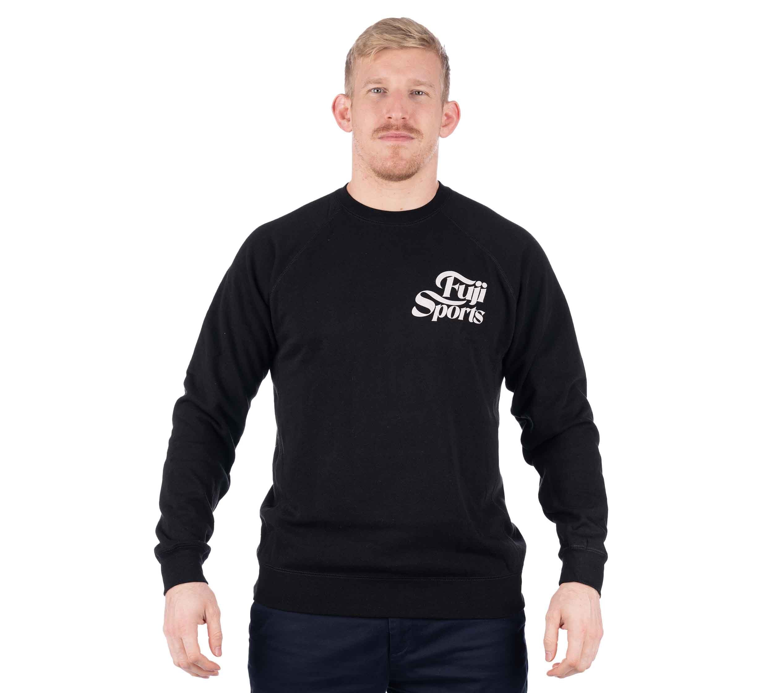 A man with short blond hair and a mustache is wearing the Wave Crewneck Men's Sweatshirt Black and dark pants, standing against a plain white background and facing the camera with a neutral expression.