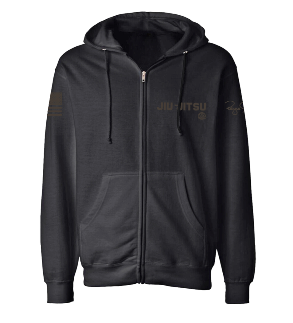 The Royce Gracie Charcoal Blackout Zip Up Hoodie YOUTH features a black zip-up design with "JIU-JITSU" in gold on the left chest, a small gold logo underneath, and subtle gold graphics on the right sleeve and upper chest.