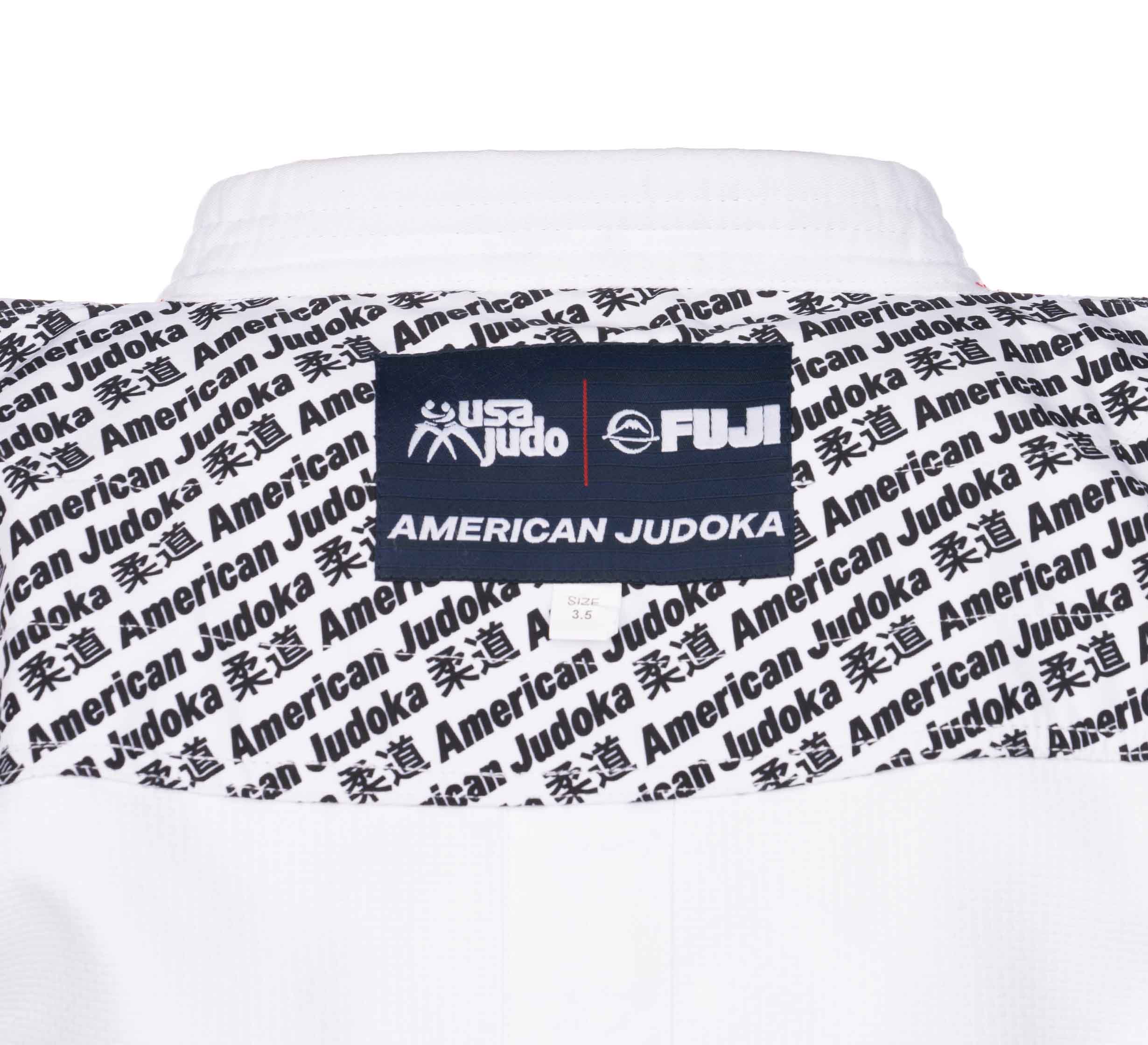 Close-up of the USA Judo Single Weave Gi 2.0 White’s back, featuring a black label with USA Judo, FUJI, and AMERICAN JUDOKA, plus a repeating American Judoka and Japanese kanji pattern.