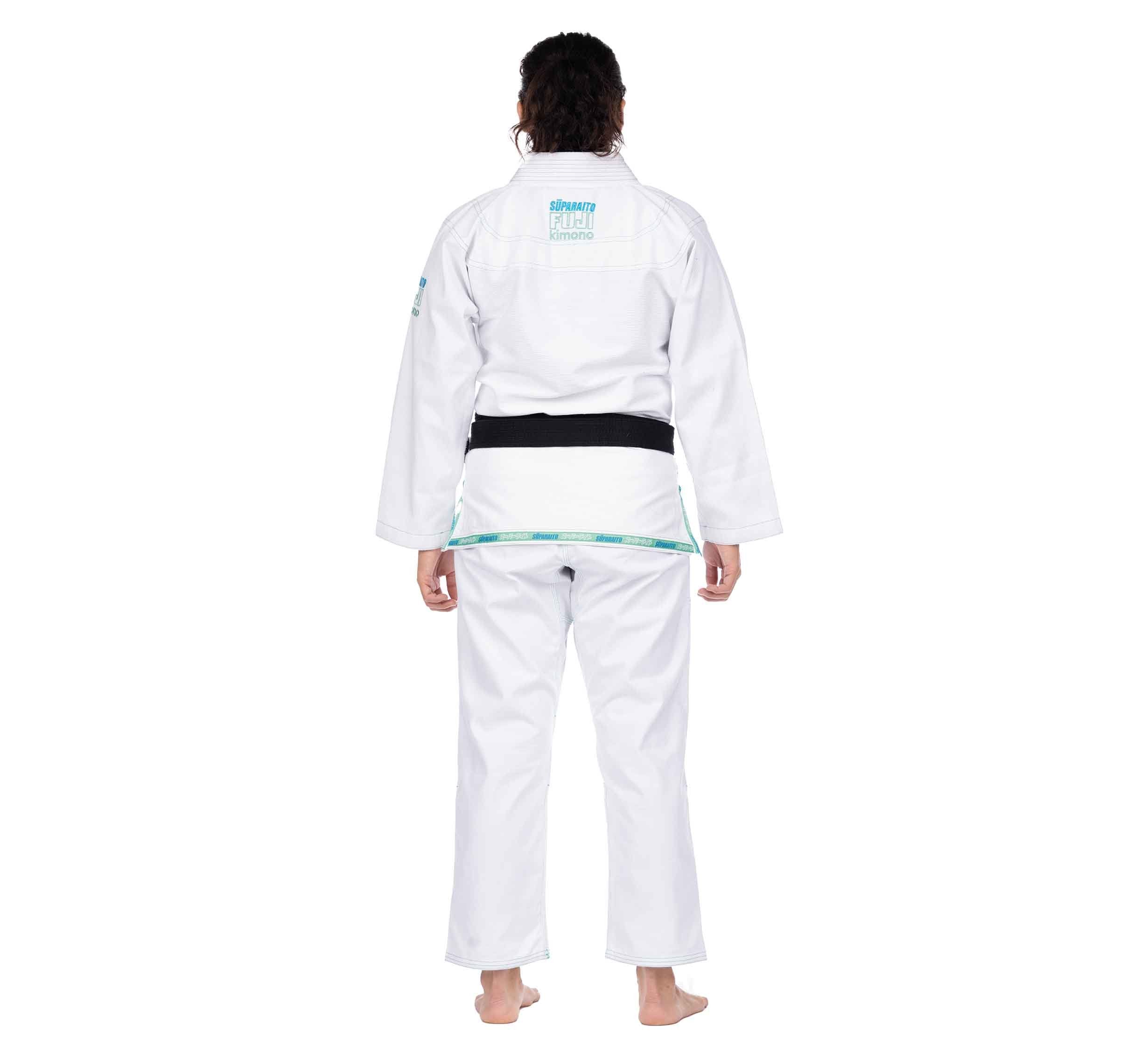 A person wearing the Suparaito Girl's BJJ Gi Teal stands barefoot, facing away from the camera, against a plain white background.