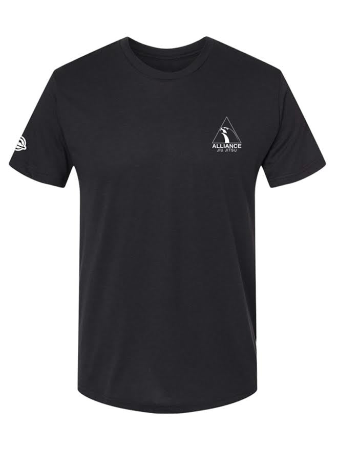 The Alliance Essential T-Shirt Black features short sleeves and a small white Alliance Jiu-Jitsu logo on the left chest, along with a circular white logo on the left sleeve. It is shown against a plain background.