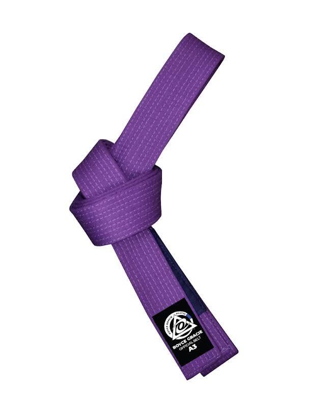 The Royce Gracie OFFICIAL Purple BJJ Belt with Blue Bar is shown tied in a knot, featuring a black label with white text and logo on one end, set against a white background.