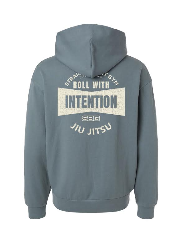 The SBG Roll With Intention Hoodie Blue features "STRAIGHT BLAST GYM ROLL WITH INTENTION SBG JIU JITSU" printed in white on the back and is shown on a plain white background.