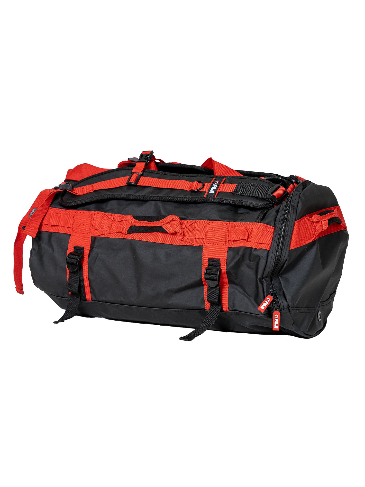 The Comp Duffle Black Red is a spacious duffel bag in black and red, featuring multiple handles, zippers, and adjustable straps, shown against a white background.