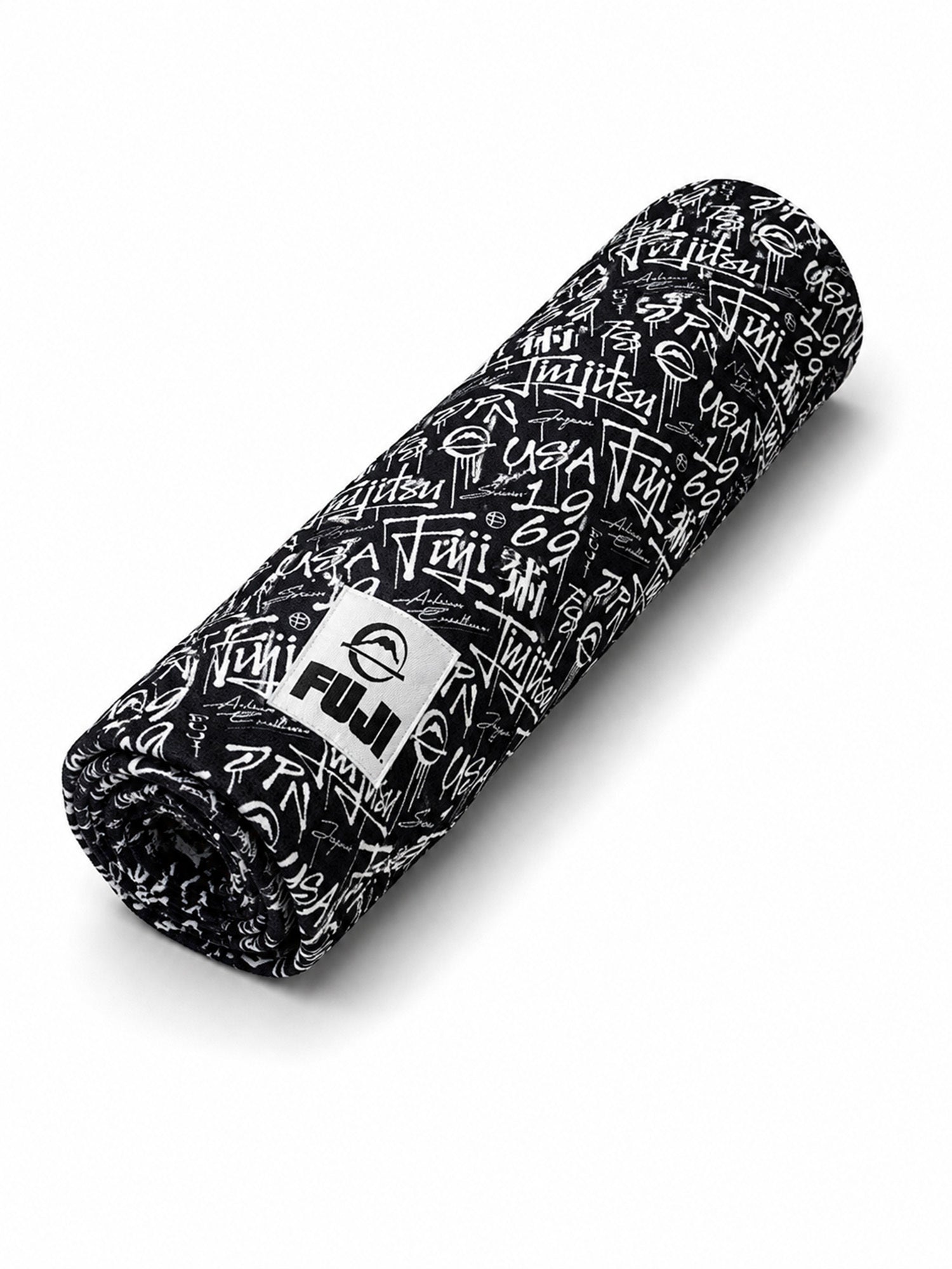 A black and white rolled-up Gym Towel featuring “Fuji” branding and various graffiti-style text and symbols printed on its surface.
