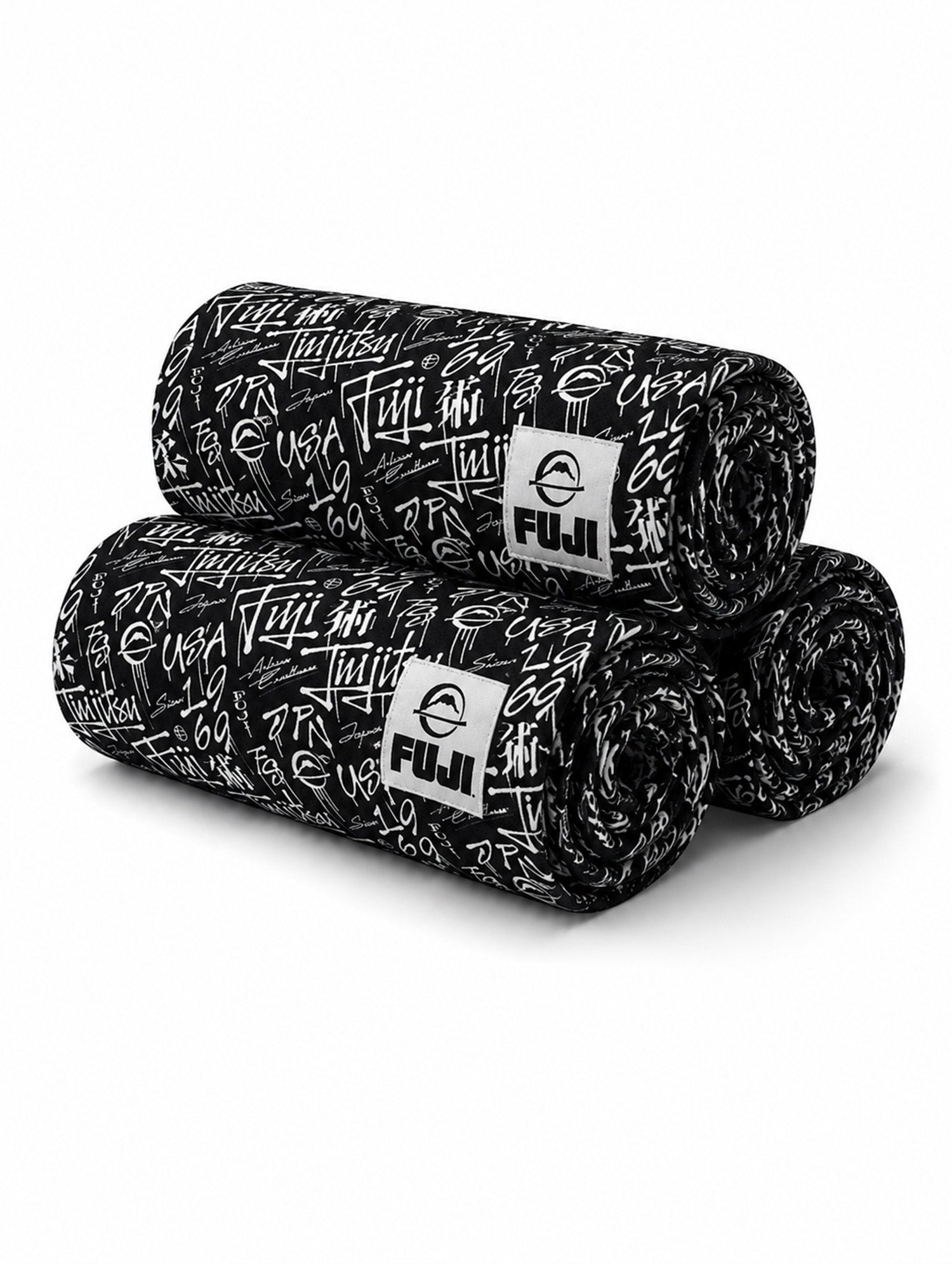 Three black Gym Towels featuring white graffiti-style writing and a Fuji logo patch on each, stacked in a pyramid shape on a plain white background.