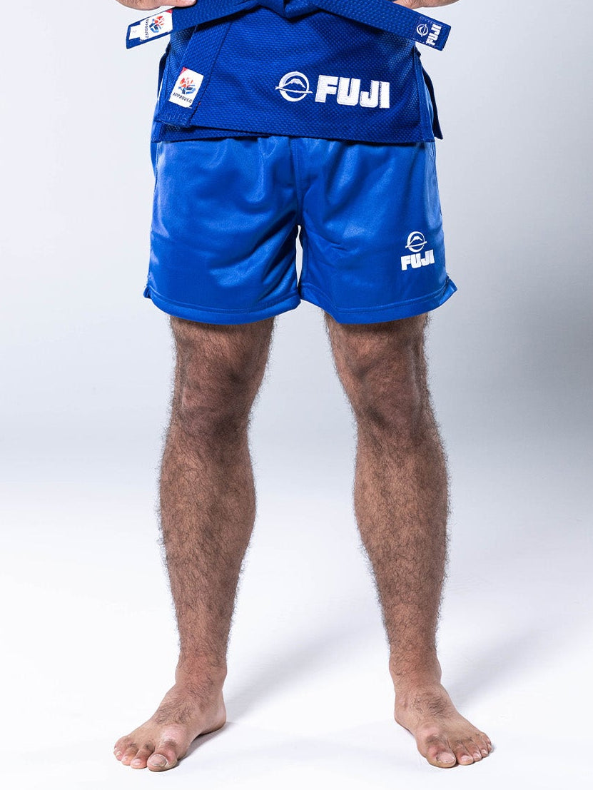 Blue FIAS Sambo Shorts worn with a matching martial arts uniform top and belt.