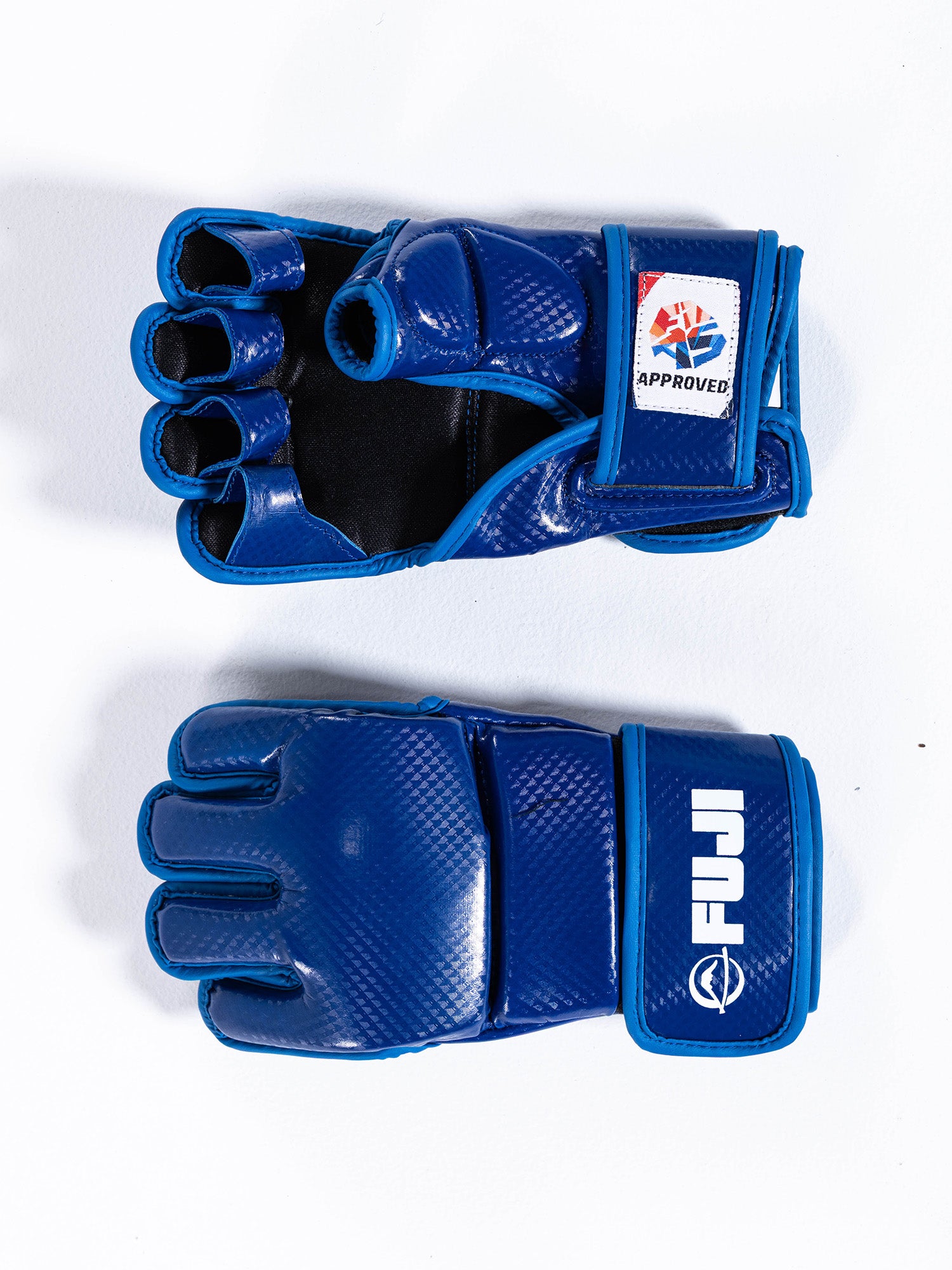 Two FIAS Sambo Combat Gloves Blue are displayed on a white surface, one with the palm facing up and the other palm-down. The gloves feature a FUJI logo and a tag showing they are approved for competition use.