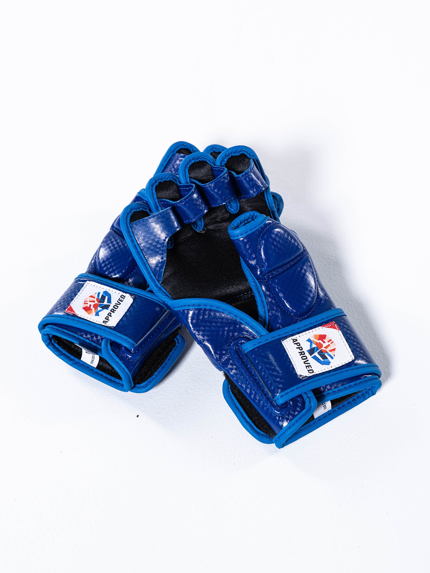 A pair of FIAS Sambo Combat Gloves Blue, featuring an MMA-style design with open fingers and velcro wrist straps, each adorned with an Approved logo patch on a plain white background.