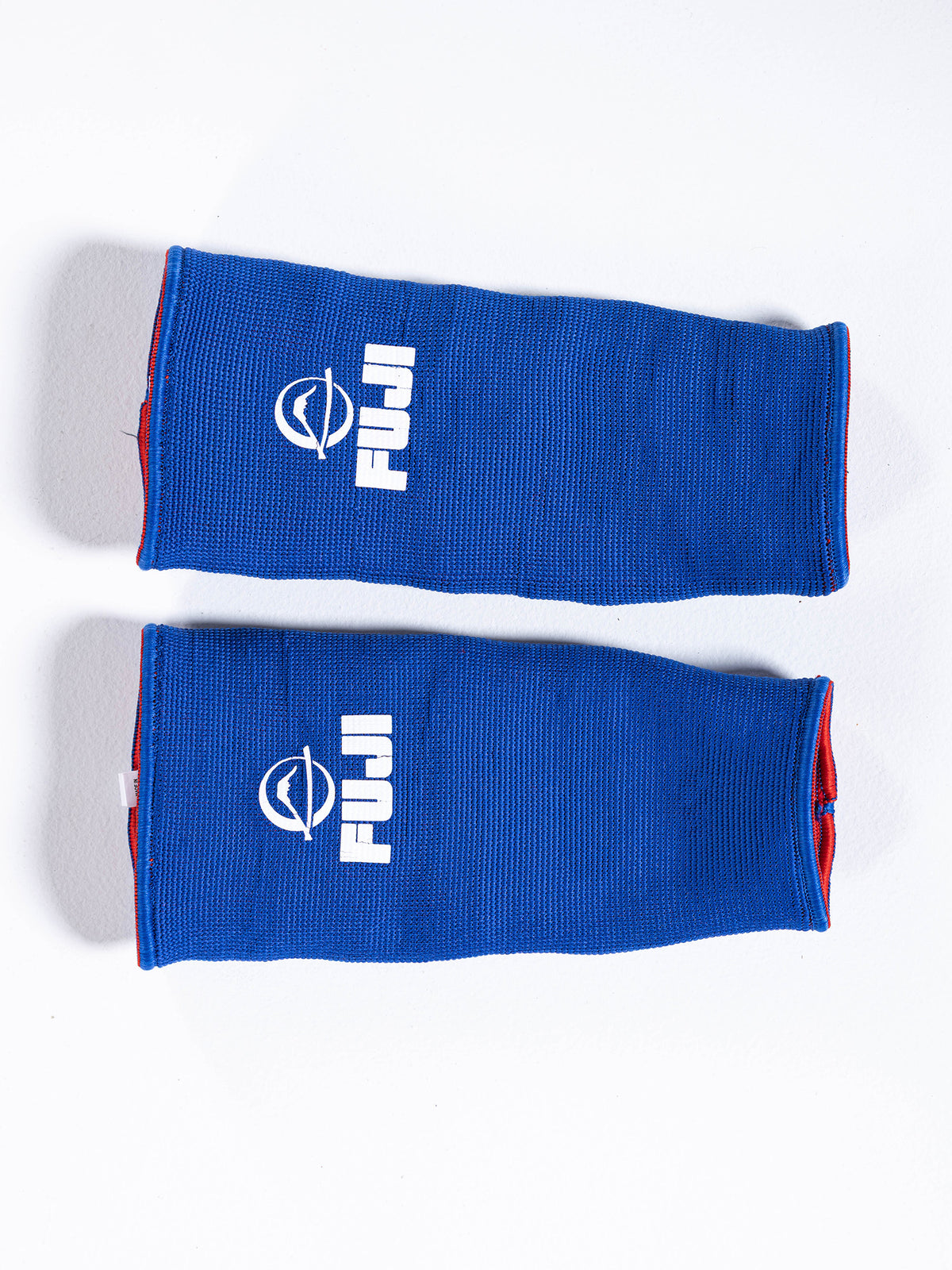 Two blue rectangular FIAS Sambo Beach Ankle Support Reversible ankle supports with white logos, lying flat on a white surface, one above the other.