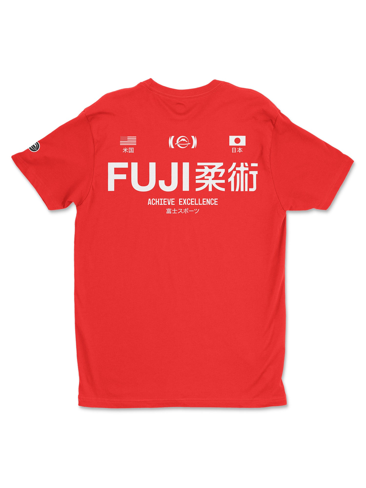 The Iconic Jiu Jitsu Shirt Red features “FUJI柔術” in large white letters on the back, “ACHIEVE EXCELLENCE,” smaller Japanese text, USA and Japan flags above, plus circular logos near the top and left sleeve.