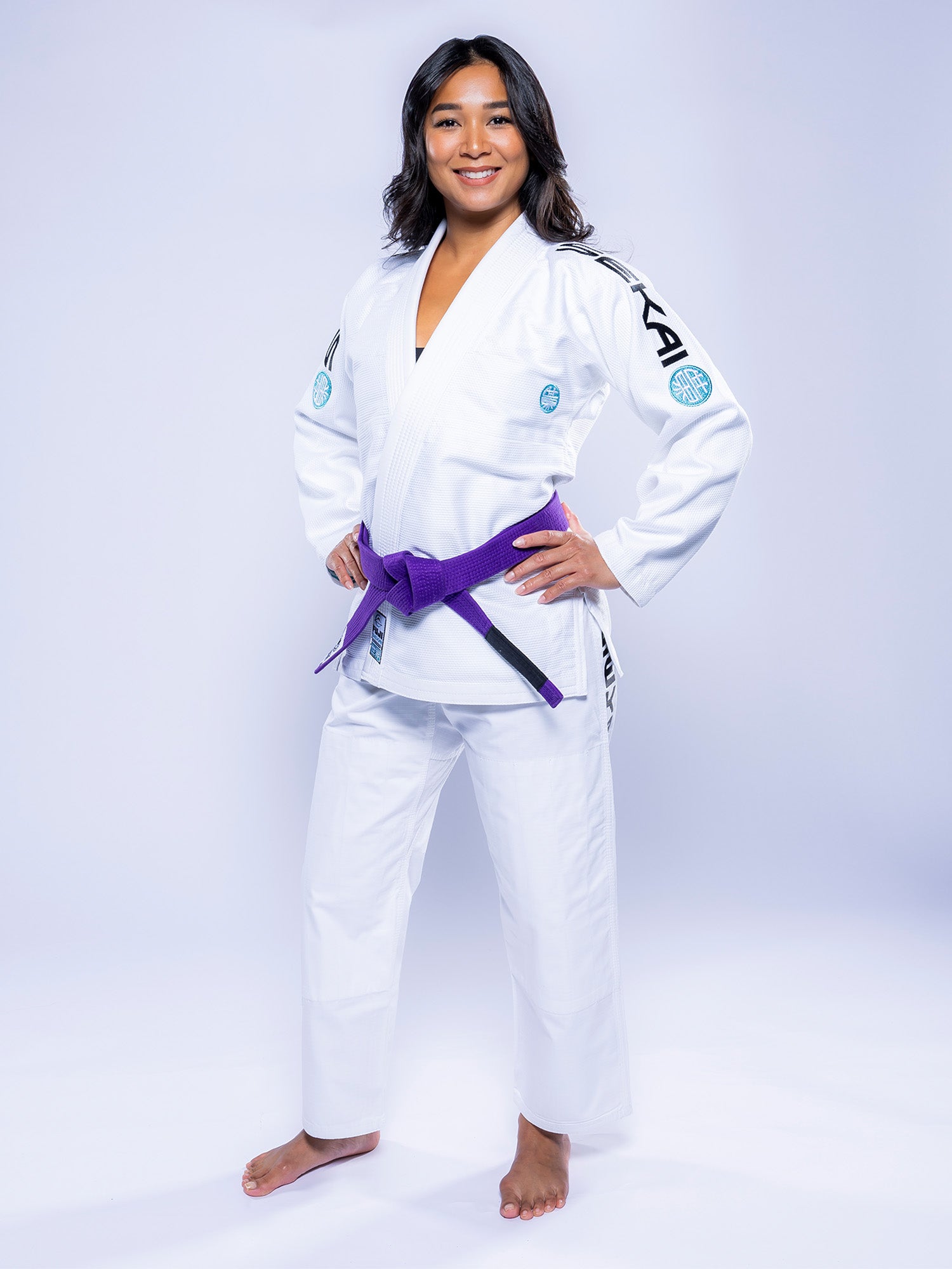 A woman wearing the Womens SEKAI 3.0 BJJ Gi in White Teal.