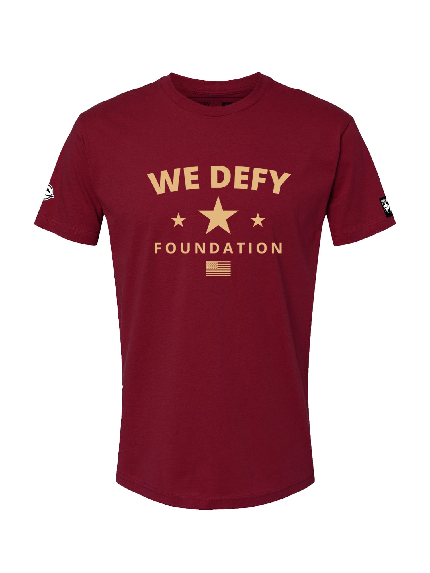 The We Defy Retro Star Cardinal T-Shirt Red features "WE DEFY FOUNDATION" in gold, three stars, and a small flag on the front, plus small patches on each sleeve.