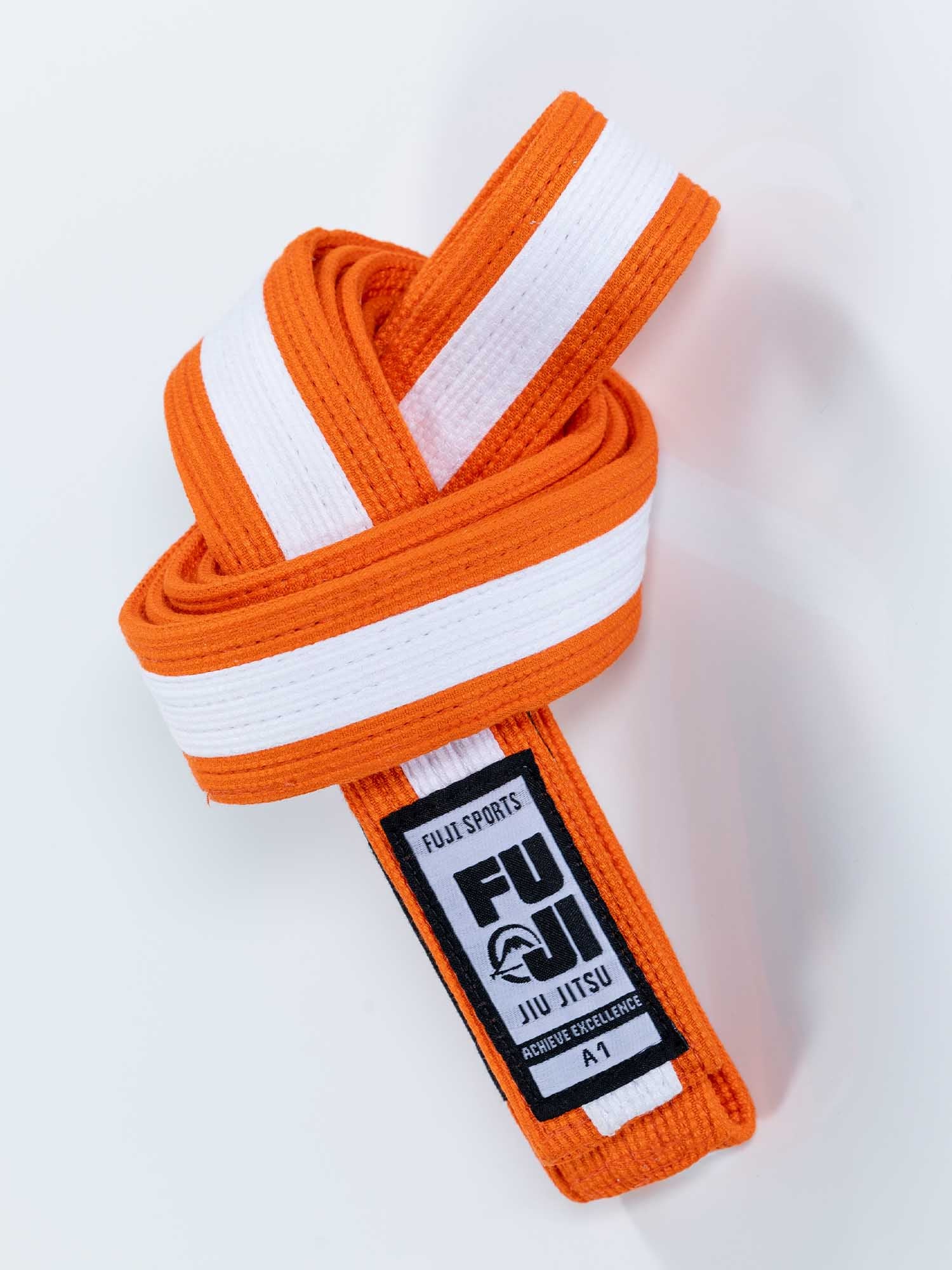 A neatly folded Pearl Weave BJJ Belt Orange White, size A1 and labeled FUJI SPORTS JIU JITSU, sits on a white background.