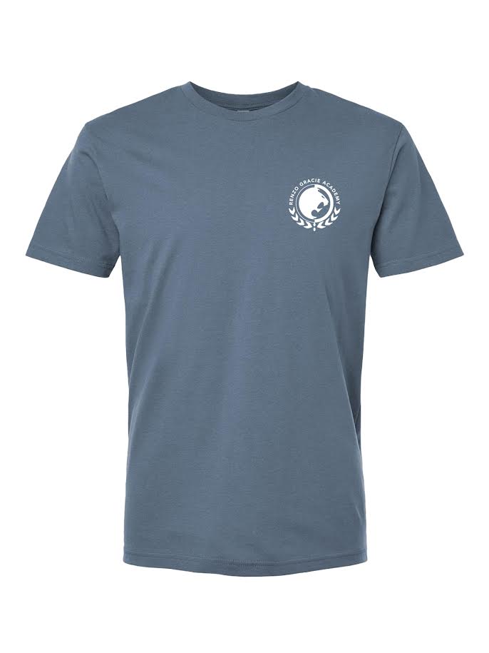 The Renzo Gracie Essential T-Shirt Blue Jean is a plain blue short-sleeve tee with a small white circular fish and laurel wreath logo on the upper left chest.