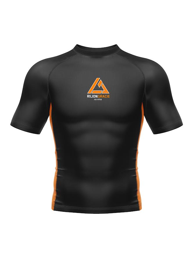 Kids Rilion Gracie Short Sleeve Standard Rashguard Orange features black and orange colors, a chest logo, orange side panels, and a fitted athletic design.