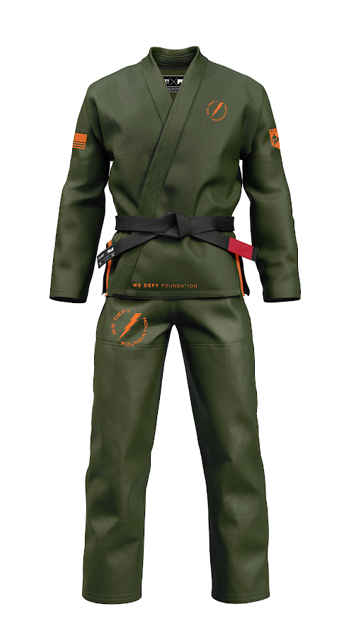 The We Defy Ripstop BJJ Gi Military Green features orange patches and embroidery, displayed on a white background. It includes a black belt and "We Defy Foundation" text on the jacket and pants.
